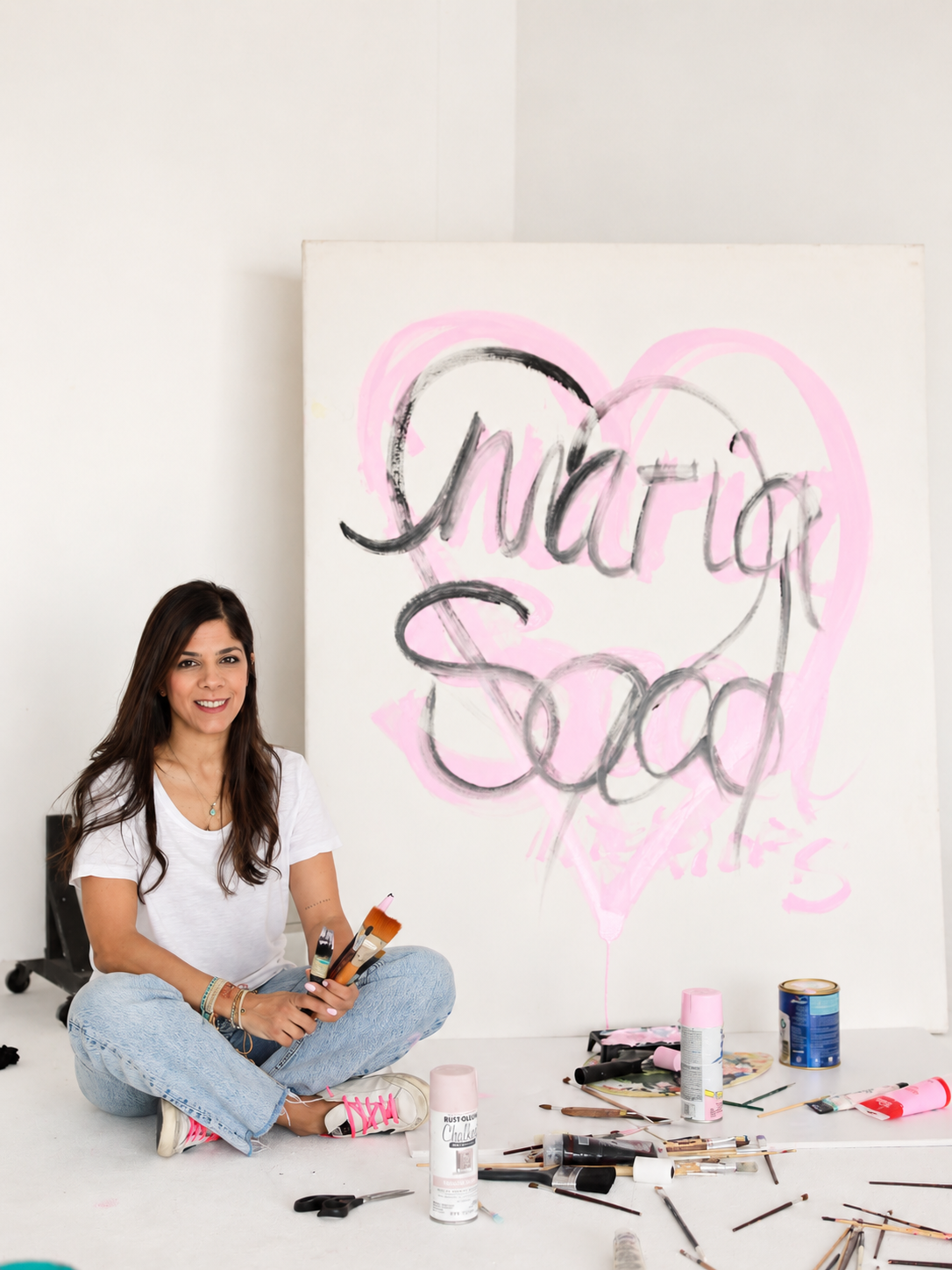 Maria Saad in her studio exploring color and textured painting materials