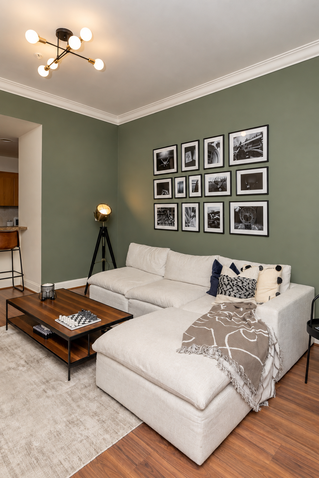 Living room with green wall, framed artwork gallery, sofa, coffee table and rug