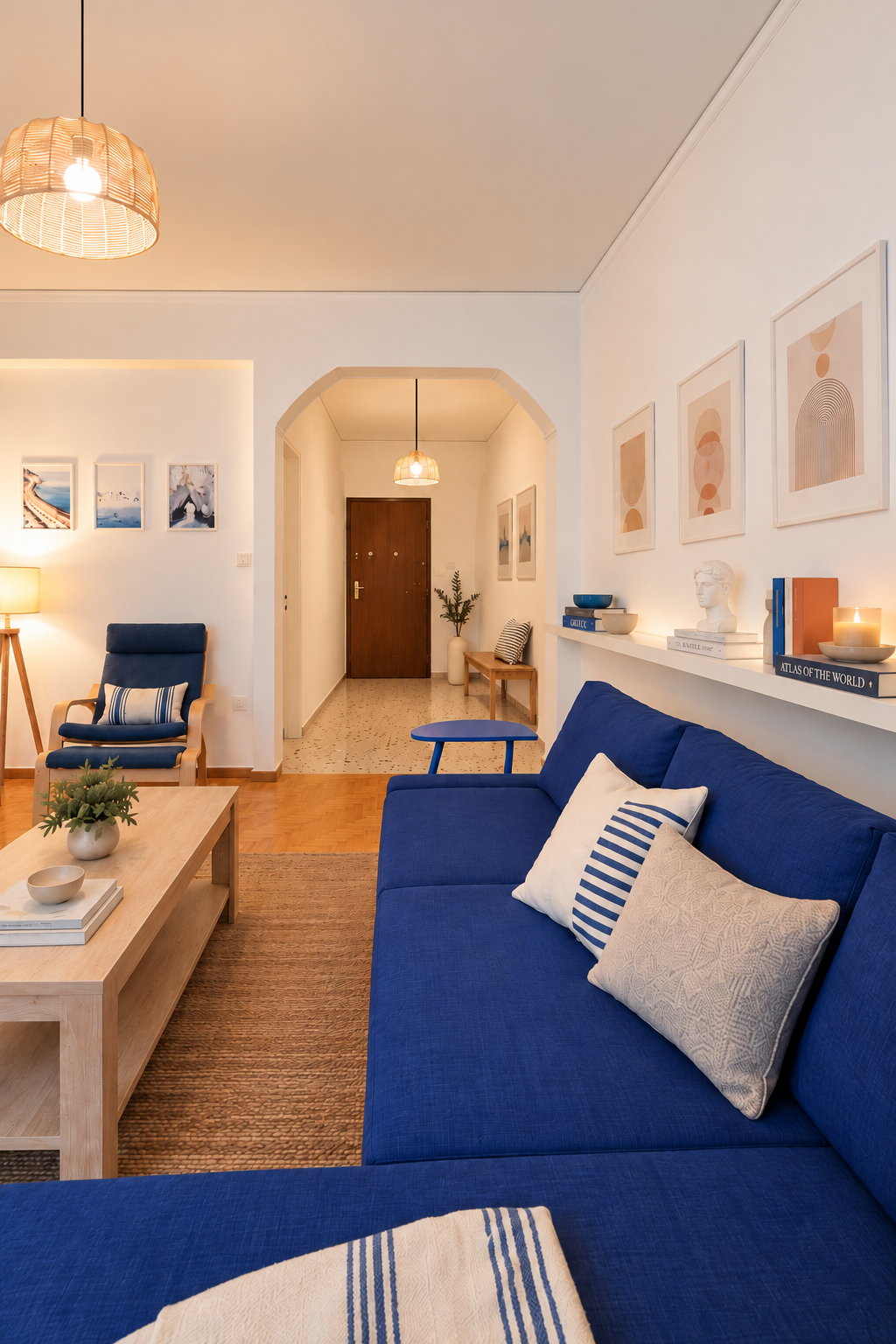 Athens Residence living room with blue sofa and arched opening toward dining and entrance area