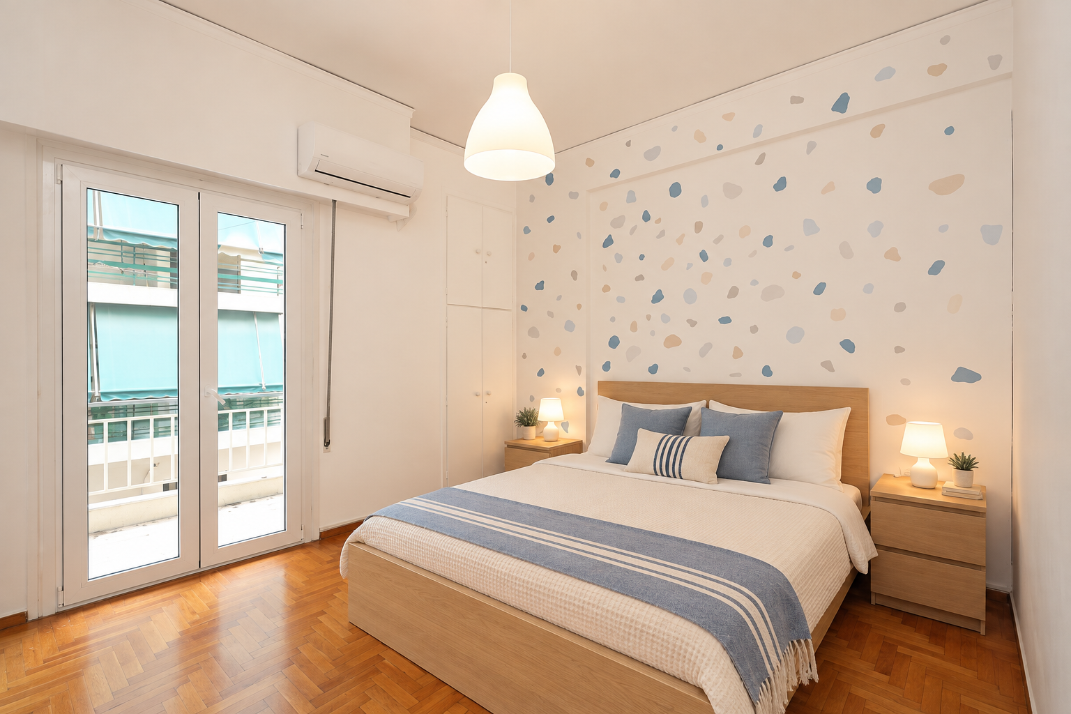 Athens Residence Bedroom 1 with wooden bed and pale terrazzo-style patterned feature wall
