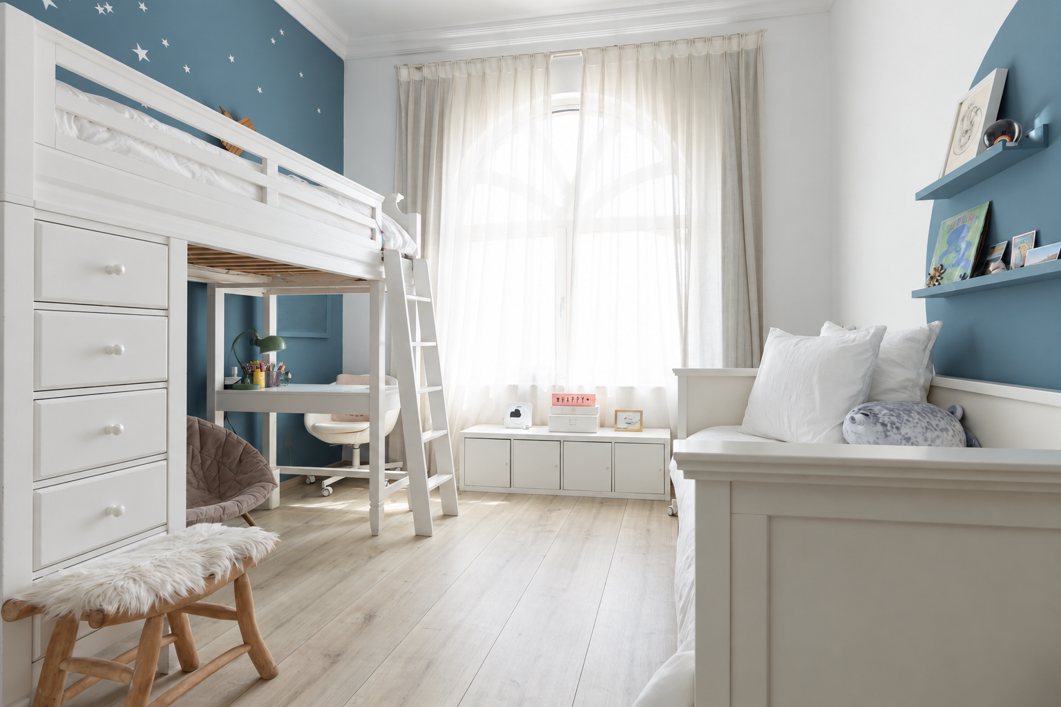Full bedroom interior showing custom loft bed, second bed, desk workstation, large arched window, blue celestial walls, and natural wood flooring