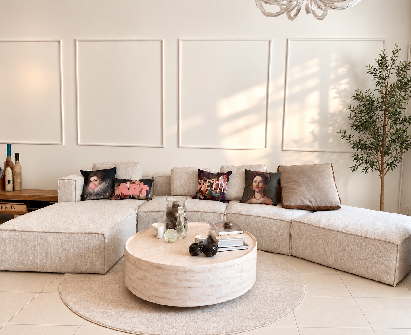 Residential interior featuring a sofa, round coffee table, wall mouldings and an olive tree